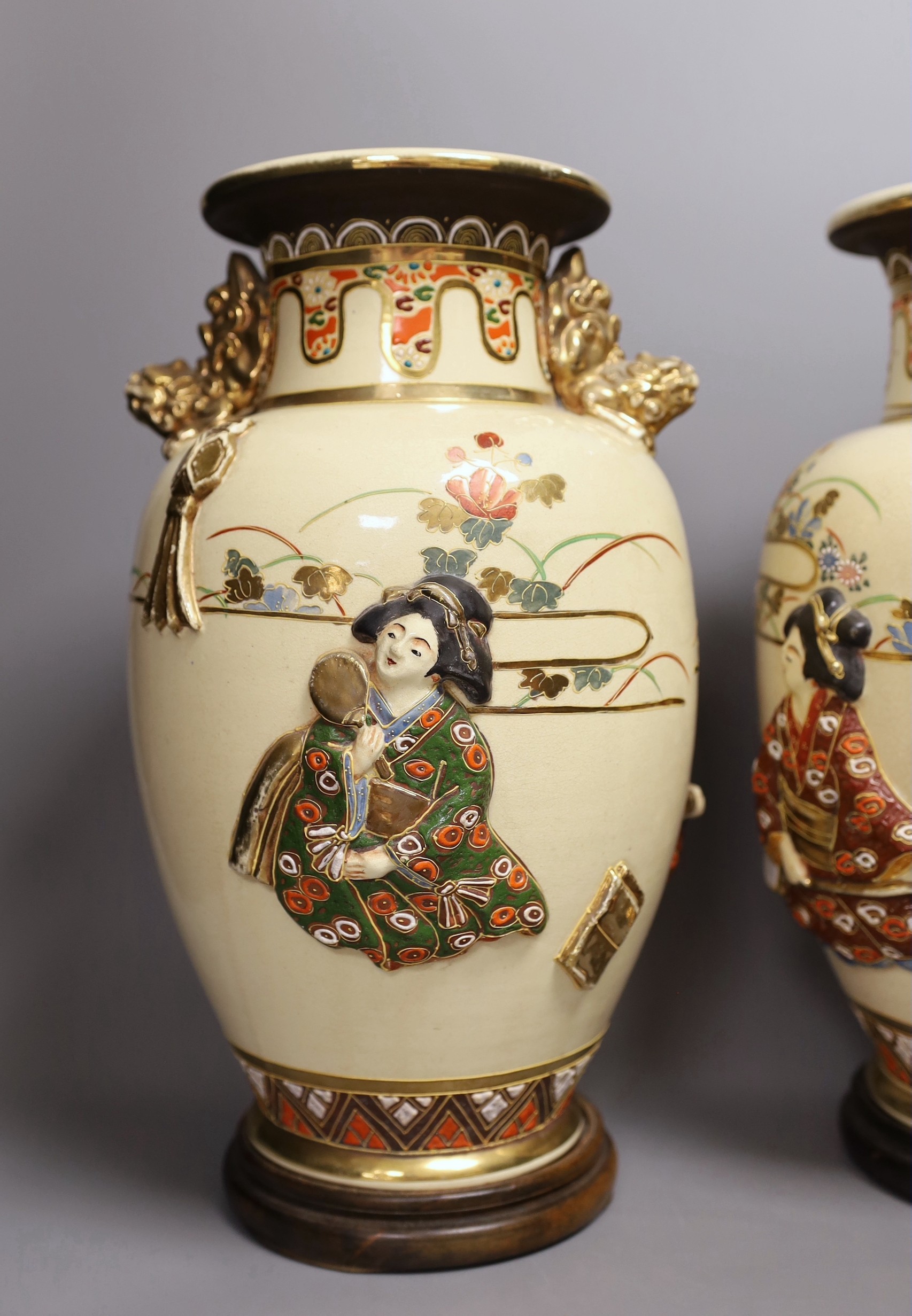 A pair of large Satsuma vases with relief decoration and dragon handles, 35cm tall with bases